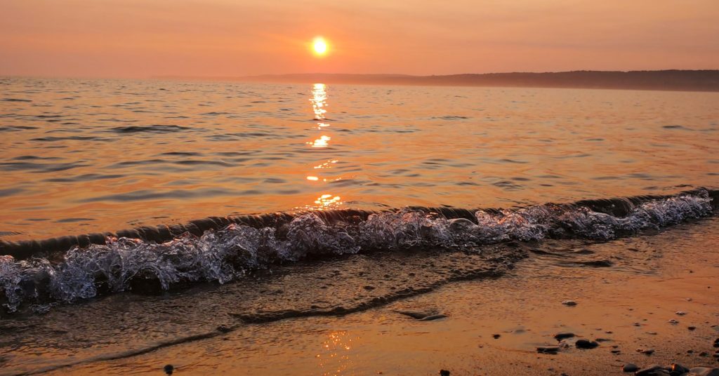 An orange sunset over the water