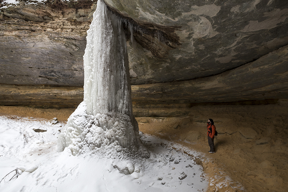 Steve standing next to a frozen tower of a waterfall