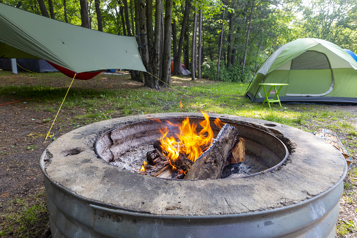 Fire pit, hammock, and tent at Sleeper State Park