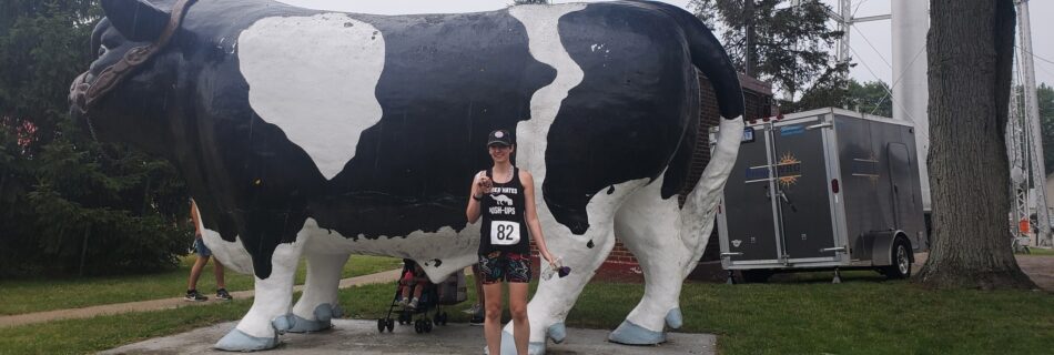 Amie at Elise Dairy Dash 5K in front of the cow