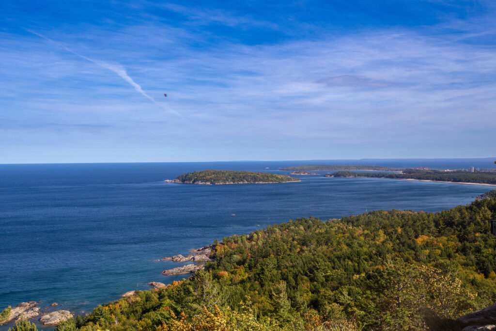 Vast Lake Superior with the city of Marquette nestled in among trees. 