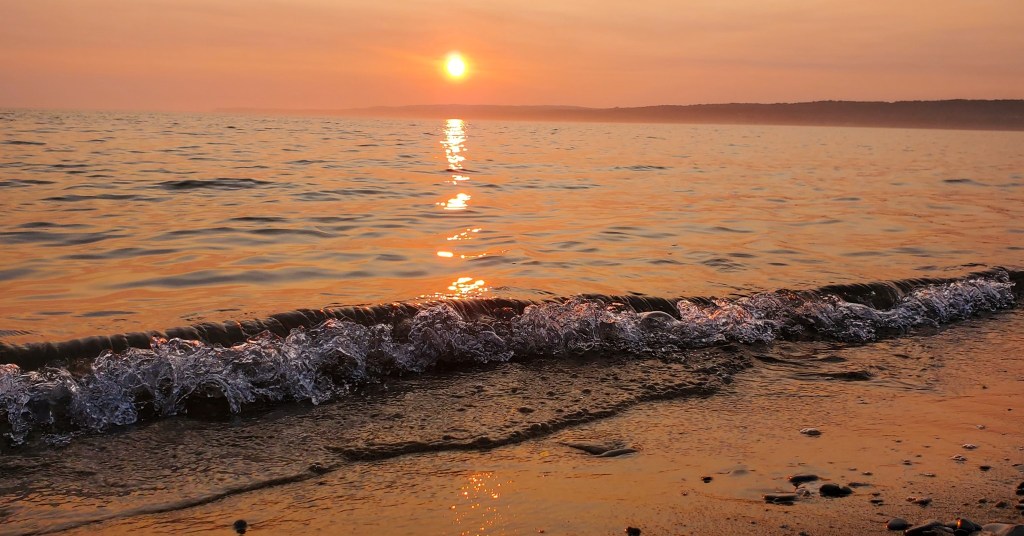 An orange sunset over the water