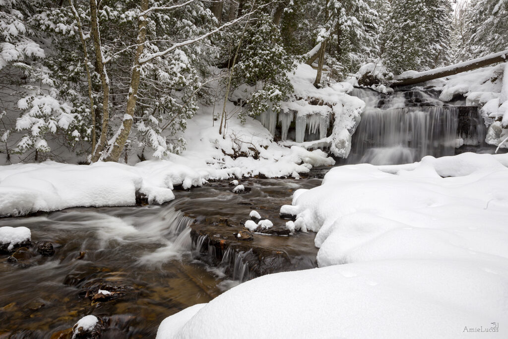 Wagner Falls cutting through a heavy blanket of snow