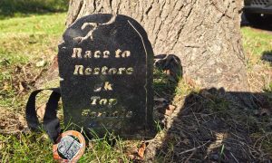Gravestone medal and finisher medal from Race to Restore