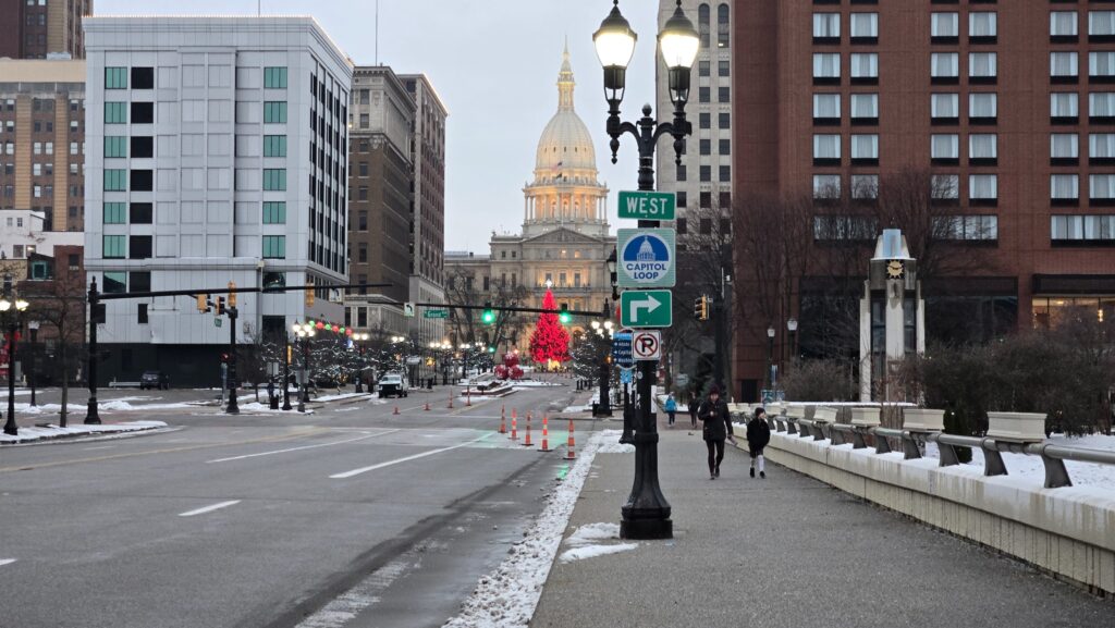 Downtown Lansing with the Capitol Building and cones marking the Holiday Classic course