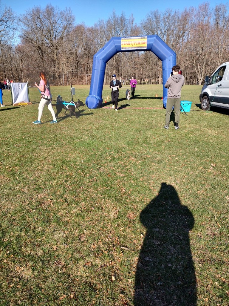 Amie crossing the finish line at the Spring Trail Trot 5K