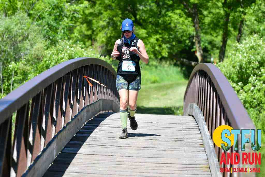 Amie crossing the wooden bridge to the Island