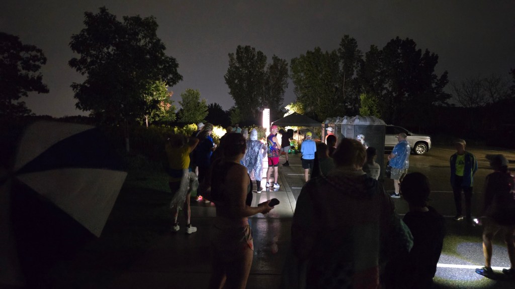A group of people at the early start line of the Millennium Meadows Marathon
